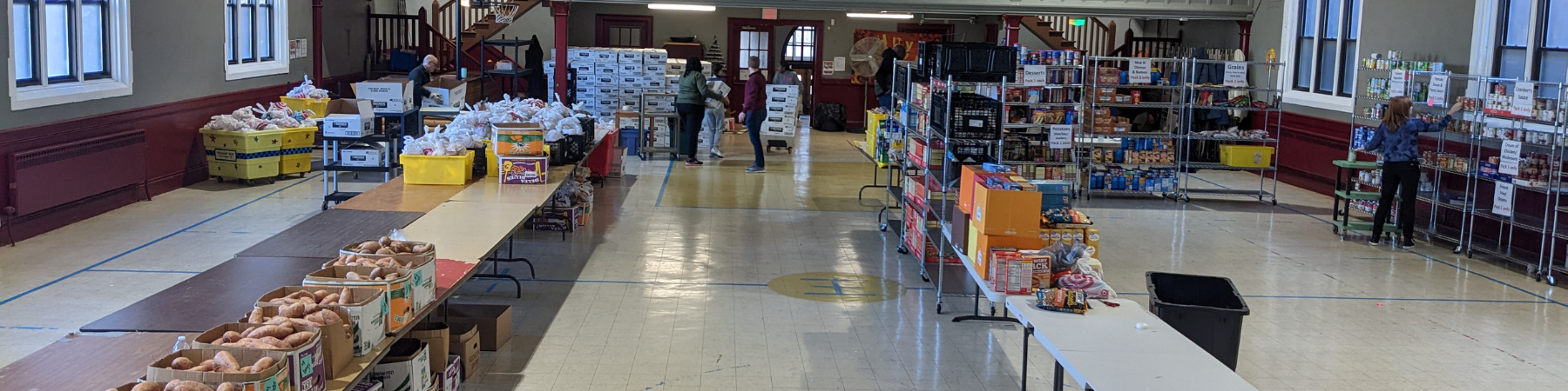 People serving at the Quinn Center food drive